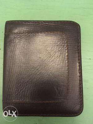 A chocolate brown Louis Viutton wallet. 2 years