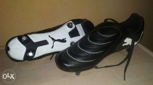 Pair Of Black And White Puma Cleats