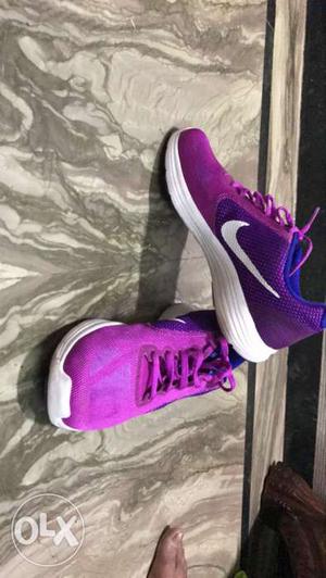 Pair Of Pink And Purple Nike Sneakers