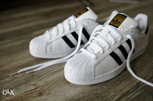 Pair Of White-and-black Adidas Superstar