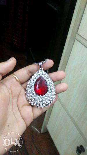 Ruby pendant encrusted within diamonds