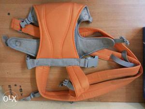 Baby's orange And Silver Carrier