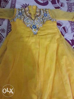 Its an beautiful yellow anarkali long suit. Embroided with