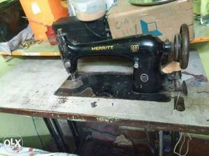 Black Merritt Sewing Machine With Table and an electric