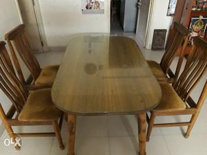 Teak wood dining table with four chairs in very