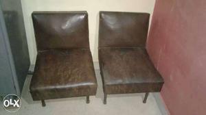 Two Brown Leather Padded Black Metal Base Chairs