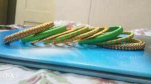 A set of 9 green thread designed bangles