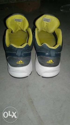 Black, Yellow, Gray, And White Adidas Running Shoes