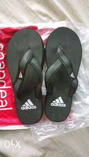 Pair Of Black-and-white Adidas Flip Flops