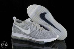 Pair Of Gray-and-white Nike Athletics Hoes