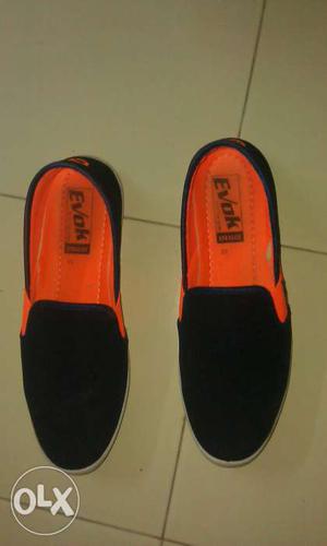 Pair Of Orange And Black Evok Slip On Shoes