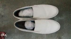 Pair Of White Leather Slip On Shoes