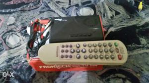 Black Electronic Device With Remote And Box