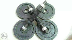 Four Black Weight Plates With Two Dumbbell Bars