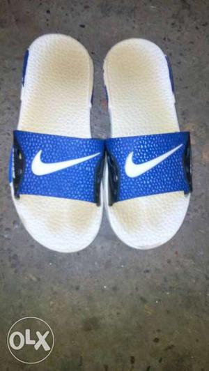 White-and-blue Nike Slide Sandals