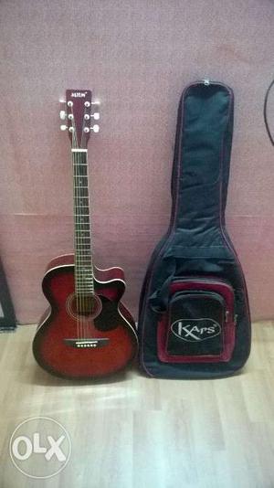 Jimm acoustic guitar (red) 5 months old. In a