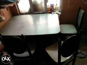 One wooden dining table with 4 chair