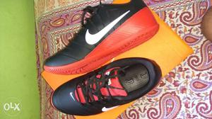 Pair Of Black-and-orange Nike Low Top Sneakers On Box