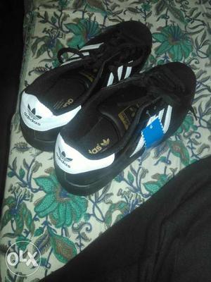 Pair Of Black-and-white Adidas Low Top Shoes
