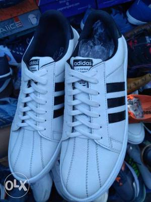 Pair Of White-and-black Adidas Low Tops