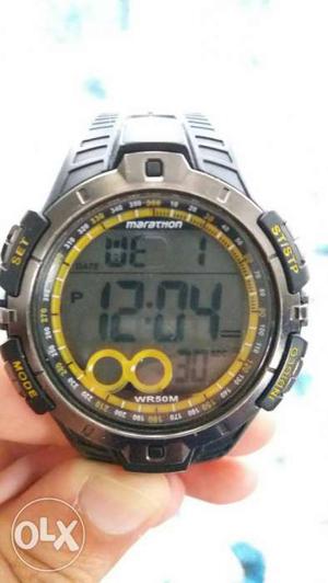 Round Black, Yellow, And Gray Marathon Wr50m Digital Watch