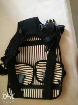 Black, Brown, And White Striped Infant Carrier