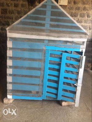 A dog house with carpentered wooden gloor and