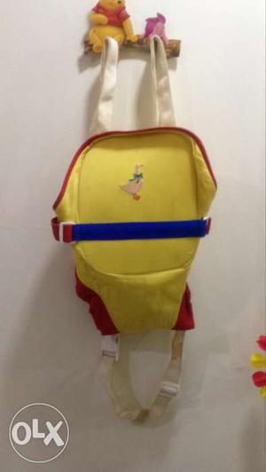 Baby's Yellow, Red, And Blue Carrier