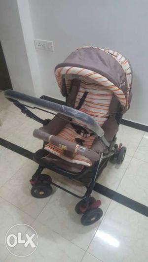 Baby's Brown And White Stroller