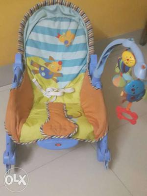 Baby's Orange, Yellow, And Blue Bouncer Seat