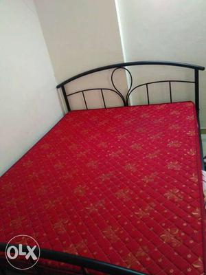 Black Steel Framed Bed With Red Mattress