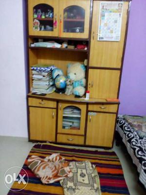 Brown Wooden Cabinet With Books And Plush Toy