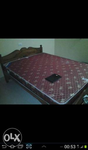 Maroon And White Quilted Mattress; Brown Wooden Bed Frame