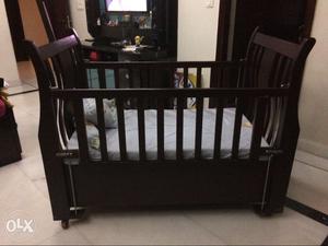 Baby cot made of wooden and it also has 2 drawers
