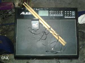 Black Alesi Guitar Amplifier With Drum Sticks