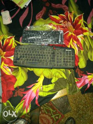 Black Microsoft Corded Computer Keyboard And Black Keyboard