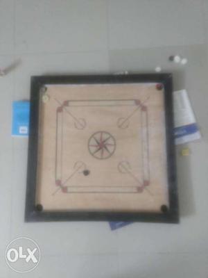 Carrom board with extra coins and striker for