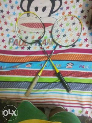 Two Yellow-and-black Badminton Rackets