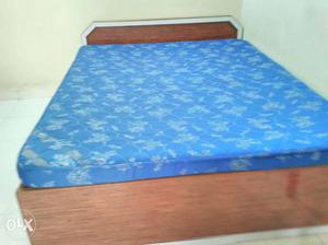 Brown Wooden Platform Bed Frame With Blue Mattress