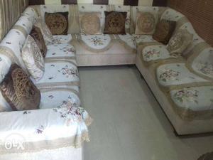 White And Beige Floral Sectional Sofa With Ten Throw Pillows