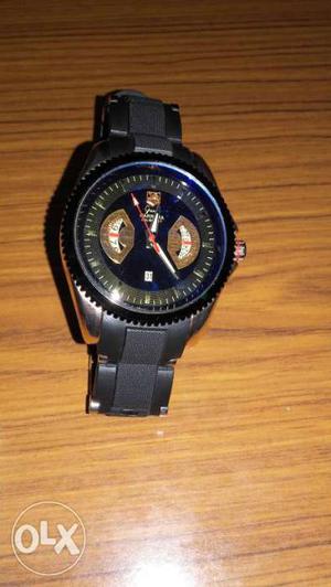 Black wrist watch. also shows date. round middle