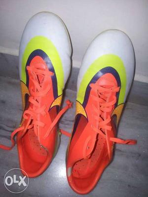 Pair Of Orange-and-white Nike Cleats