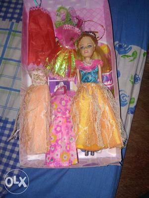 Blonde Haired Female Doll In Pink Blue And Yellow Dress