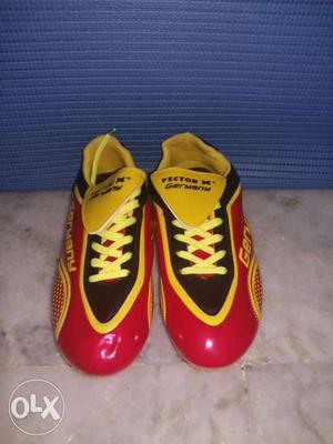 Pair Of New Red-yellow-and-black Vector Boots of football.