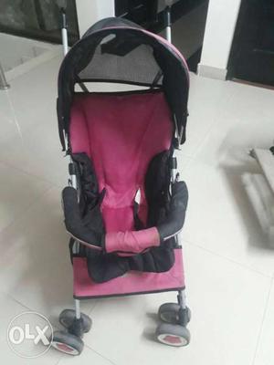 Baby's Black And Pink Stroller