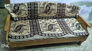 Heavy wooden three seater sofa in good condition