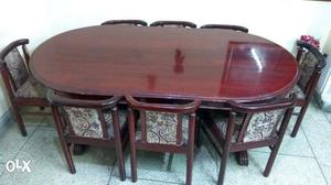 Oval Brown Wooden Table And Eight Chairs