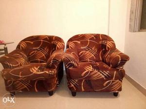 Two Brown And Black Fabric Sofa Chairs