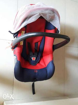 Bright Red and Blue Baby car seat and rocker in