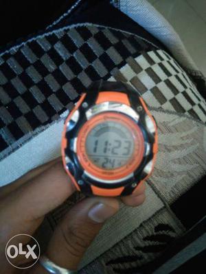 Round Digital Watch With Black And Orange Strap
